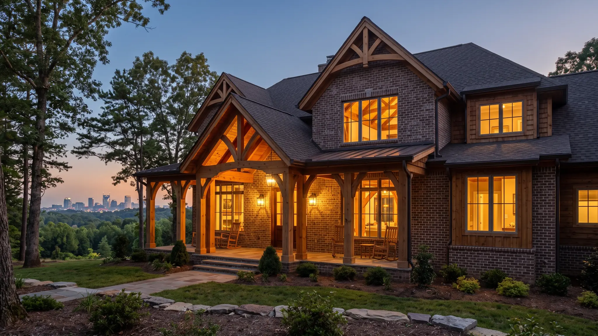 Music City Carpenter | Carpentry in Nashville, TN A custom-built Tennessee brick and timber home at dusk with warm lit windows and a cedar covered porch, with the Nashville skyline softly visible in the distance